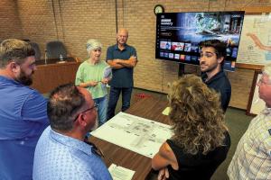 La Grange Main Street Manager Caleb Parks (top right) speaks with members of the public and the Council about the newest downtown parking design. Photo by Andy Behlen