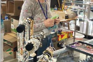 Cheri Balla, a dedicated volunteer from St. James working the bustling jewelry counter.