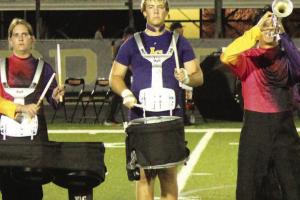 Travis Hill the Leps varsity football player, left, and Travis Hill, right, as he looks after taking off the jersey and shoulder pads and grabbing his snare drum with the Leopard Marching Band every Friday night. Photos by Jeff Wick