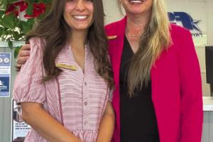 Fayette Savings Bank's Nicole and Sarah posing in pink to honor Dolly Parton.