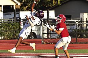 La Grange’s Howard “Skip” Holmes leaps high to bat away this pass attempt by Columbus during Friday’s game. Photo by Darrell D. Gest