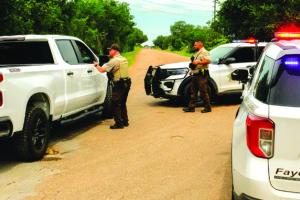 Fayette County Sheriff’s deputies blocked Old Plum Highway ahead of the scene of Wednesday’s fatal shooting. Photo by Andy Behlen