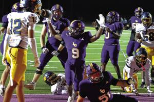 La Grange’s Dillan Johnson signals touchdown after his fifth score of the night late in the fourth quarter clinched the win Friday for the Leps. Photo by Darrell D. Gest