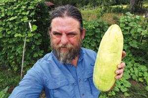 Andy Behlen with a whopper of an Xylangouro melon, which tastes a lot like cucumber.