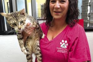 Gardenia Janssen Animal Shelter Director Tiffany Reid holds Puffy, who is happy and healthy and a far cry from how he looked when he arrived at the shelter covered in tar (photo downpage). Photo by Jeff Wick