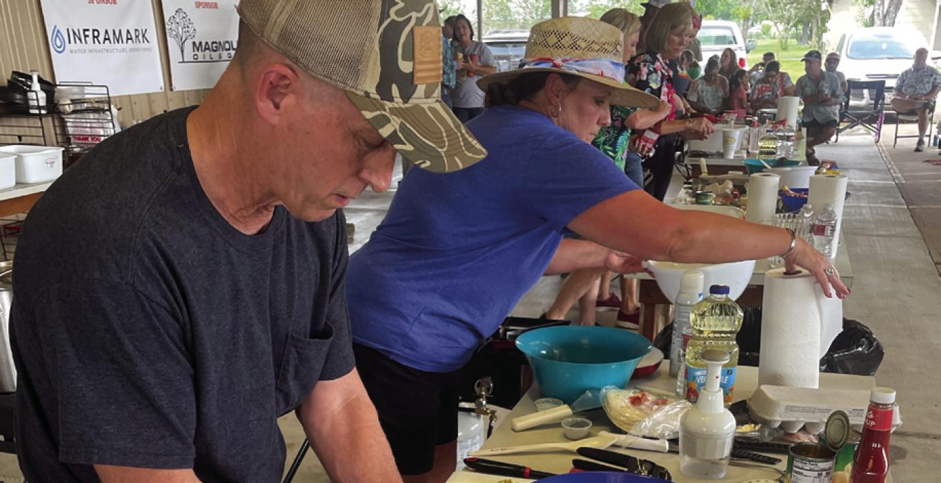 The Ellinger Chamber of Commerce hosted the 86th Annual Ellinger Tomato Festival this past weekend. Festivities included a “Chopped” cooking competition. Pictured above is a scene from the final round on Saturday, May 27. Team “Tropical Mushrooms” won the competition. Team members were John LeBlue and Kelly Vitek, pictured above. Photo by Andy Behlen