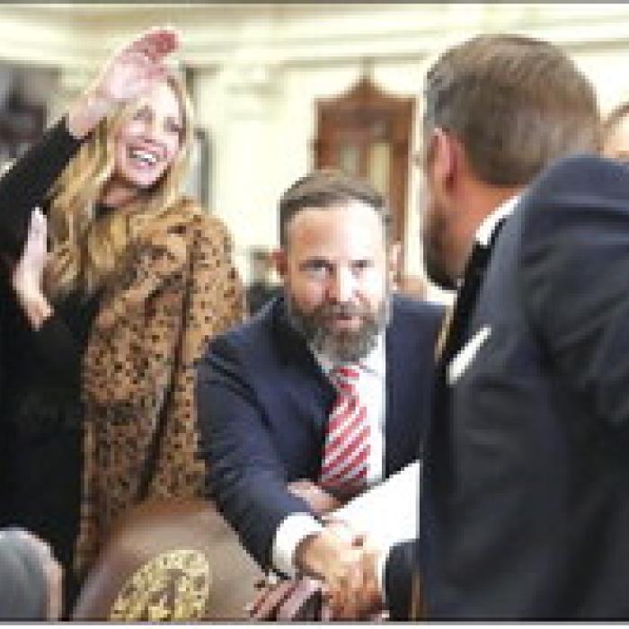 State Rep. Dustin Burrows (R-Lubbock) shakes hands with Rep. Jeff Leach (R-Plano) during opening day ceremonies on the House floor on Tuesday, Jan. 14. Bob Daemmrich for The Texas Tribune