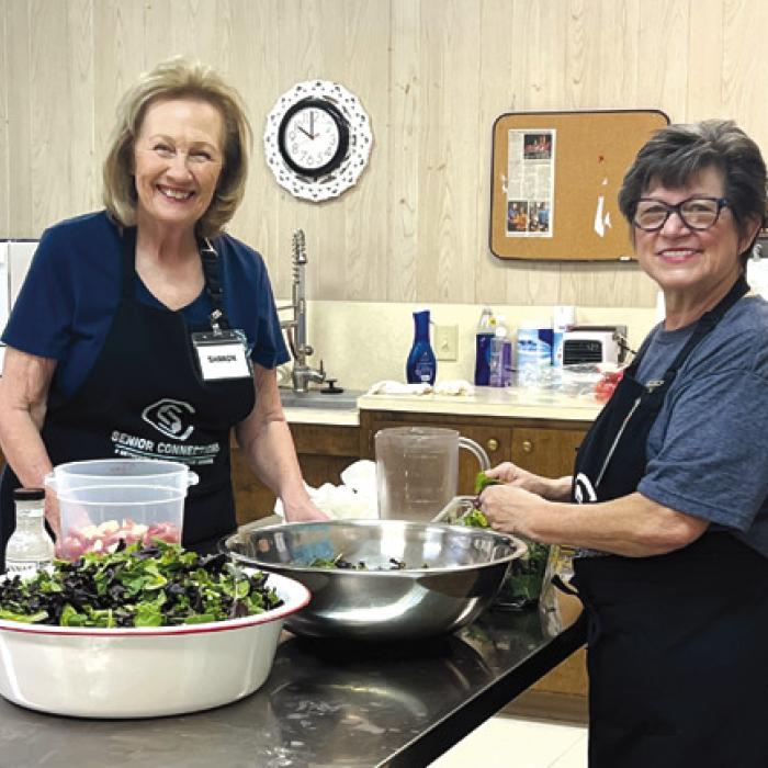 Two valued volunteers, Sharon Rodriguez and Brenda Ray, are the salad masters on duty. Members love what they create with spinach, seasonal fruits and the “secret sauce”.