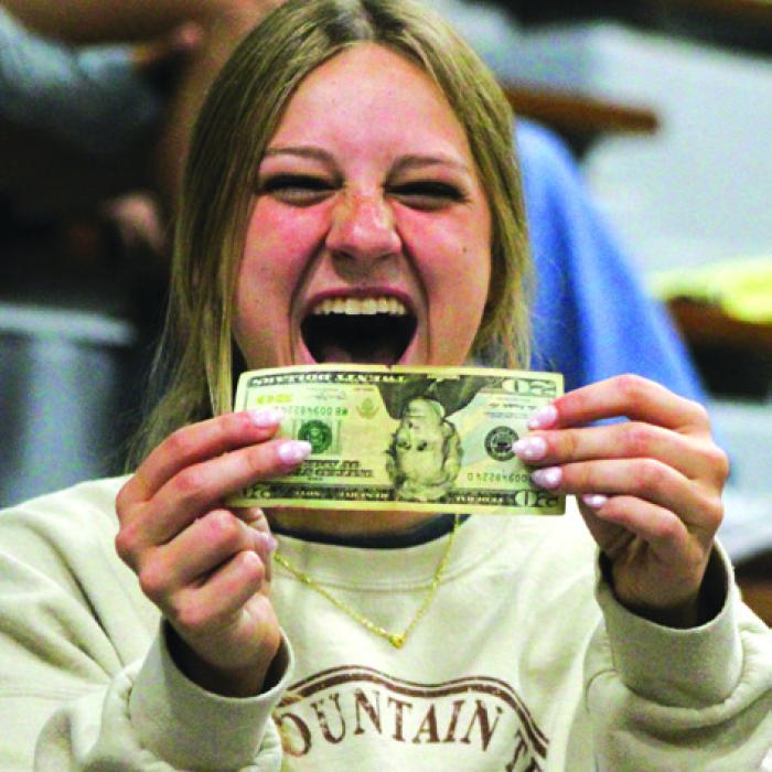 Senior Bailey Swisher reacts to finding a $20 bill in the letter she sent herself as an 8th grader. Photo by Meadow Taylor-Marklin
