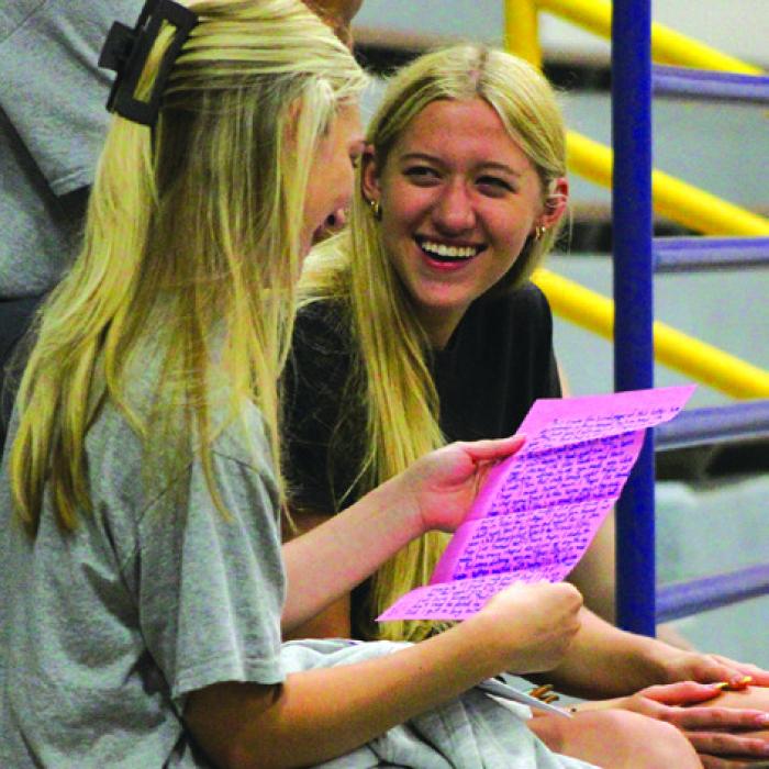 Seniors Kylie Trlicek, left, and Carley Ulrich, right, laugh as they read their letters Monday. Photo by Meadow Taylor-Marklin