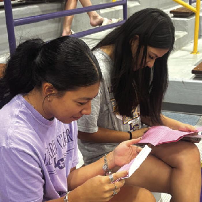 Seniors Kaylee Soto and Natalia Soto intently read the letters from their 8th grades selves Monday. Photo courtesy of Kim Newton