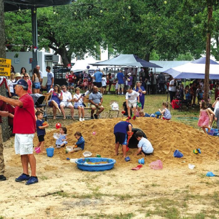 Kids played in the popular (and free) sand pile at St. John.