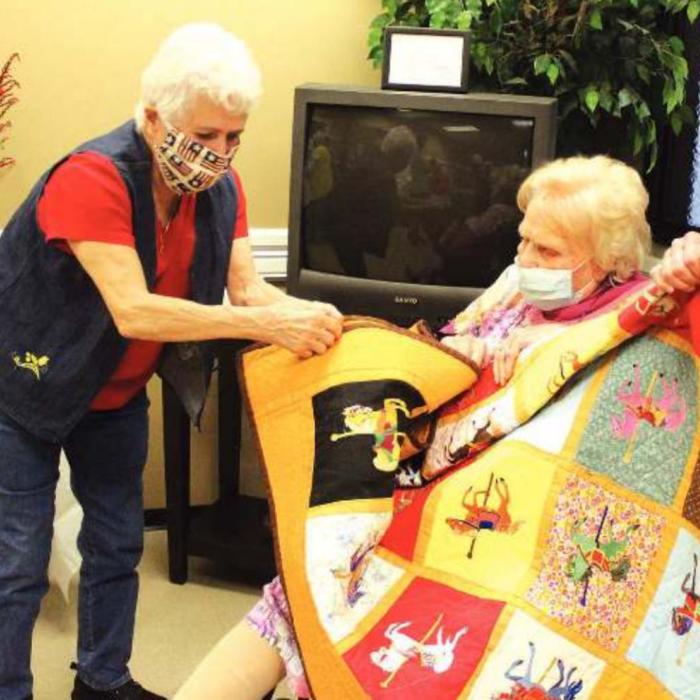 La Grange’s Jo Anne Gore presents Jo White with a quilt she made especially for her.