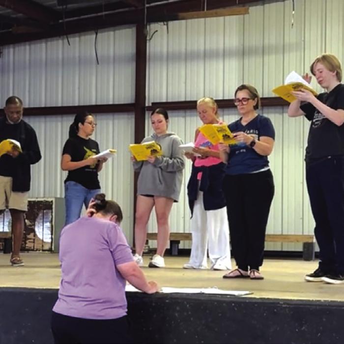 Actors, from left to right, are Katy Beauford, Gregory Rhodes, Sam Rios, Amy Christen, Melissa Weltner, Blythe Cone, Elliot Cone, and Shane Huffstutler. Tiffany Denham is in front directing. Photo by Kristen Denham