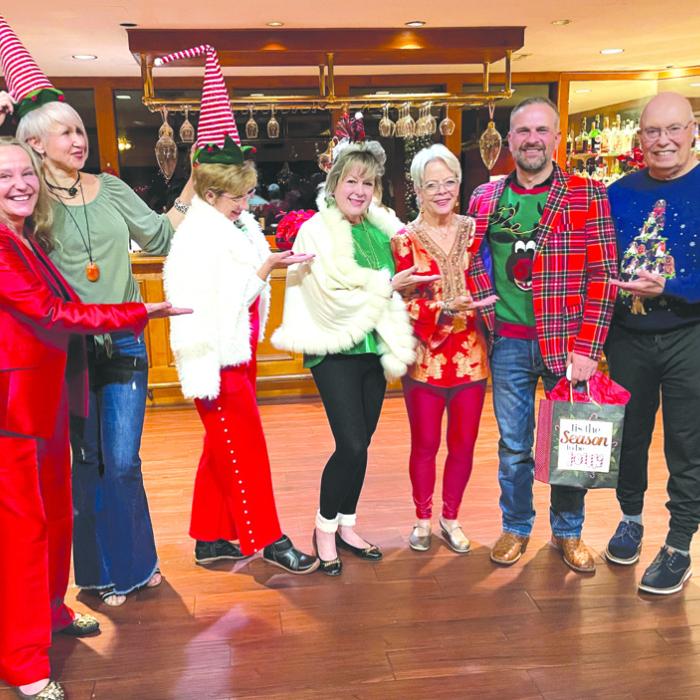 During the La Grange Noon Lions Club annual Christmas party the most festive outfit was awarded to Lion Gregory Kallus. Pictured from left to right are Melissa Weltner, Lada Kubrak, Ruby McGill, Diana Wilson, Adrienne Armstrong, Gregory Kallus, and Bill Bailey.
