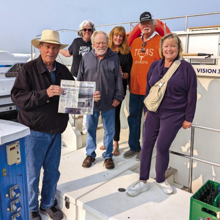 Charlie and Seri Davis of La Grange, Frank and Linda Jones of La Grange and Scott and Jan Hughes of Round Top captained a houseboat in Holland cruising the canals around Amsterdam for seven days. It rained every day with 20 MPH winds and cold temps but as soon as the sun came out they took a picture with their favorite newspaper.