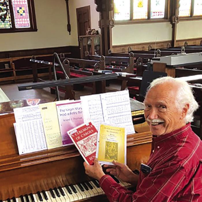 Don Kirby at the Steinway, planning the Christmas program.