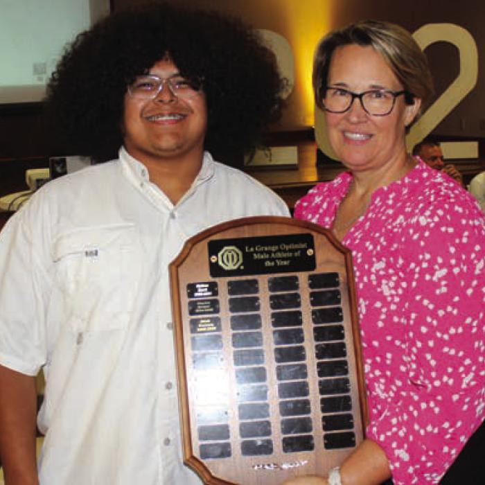 Erick Guevara, left, was the winner of the Charles Koether Male Athlete of the Year Award, presented by the La Grange Optimist Club. Misty Touchet, right, presented the award.