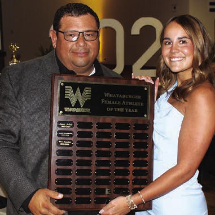 Clara Bundick, right, was the winner of the Whataburger Female Athlete of the Year Award, presented by Curt Harbers, left.
