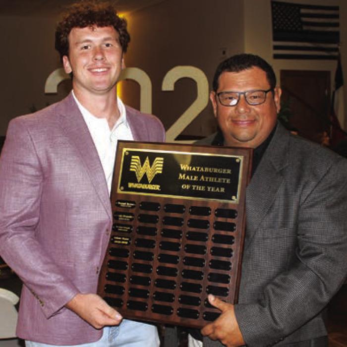 Oliver Gunn, left, was the winner of the Whataburger Male Athlete of the Year Award, presented by Curt Harbers, right.