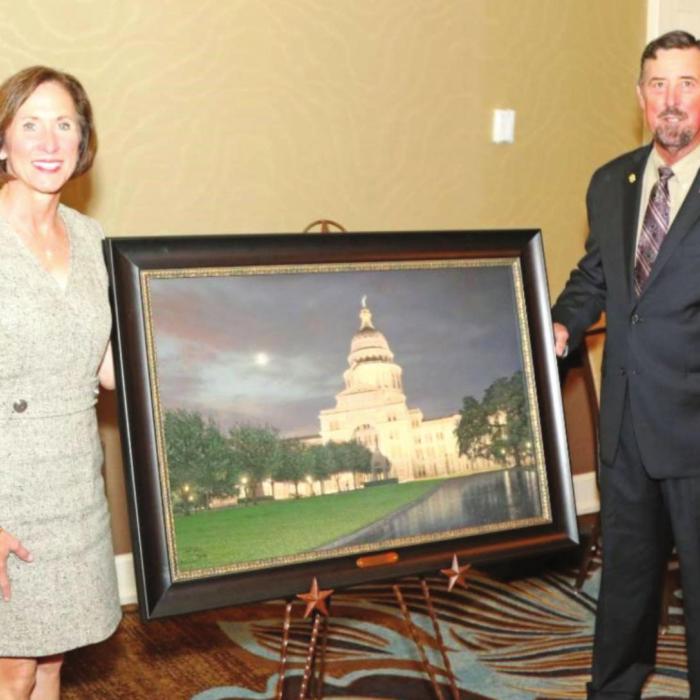Senator Kolkhorst is presented the S.M. True Agricultural Champion Award from TFB President Russell Boening.