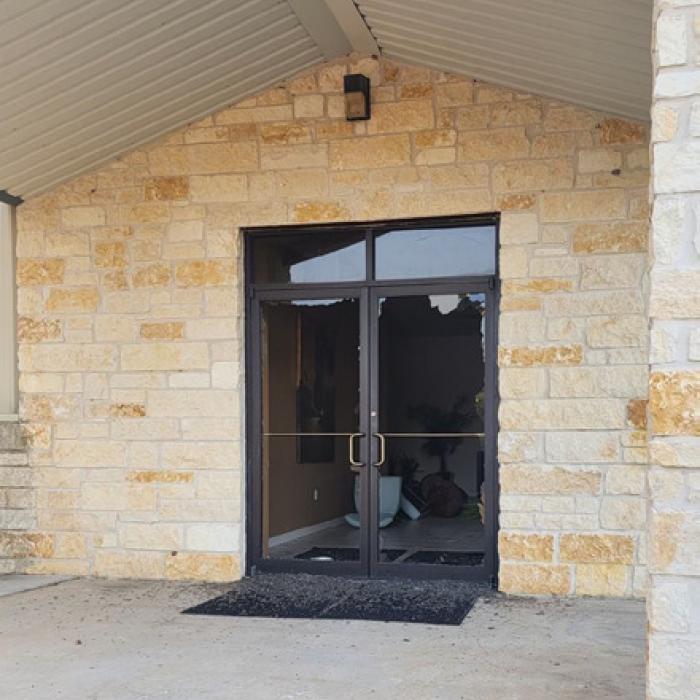 The glass front door of New Bethel Missionary Baptist Church, left, was broken along with several windows. The church, which is located on Loehr Rd. near Mullins Prairis, was also ransacked on the inside. Right, a screenshot from surveillance video at Mullins Prairie Store shows one of two burglars who broke into the establishment and stole several thousand dollars in beer and liquor.