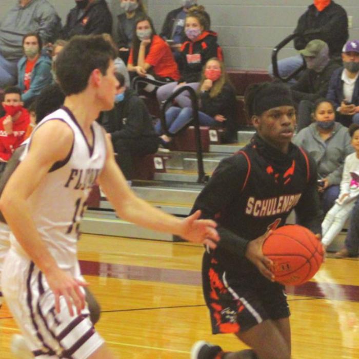Schulenburg’s Kenny King dribbles the ball down the court against the defense of Flatonia’s Collin Bosl Saturday. Photo by Brian Pierson