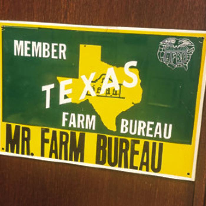 A sign hanging on the wall next to Rohde’s desk sums up his career succinctly: Mr. Farm Bureau.