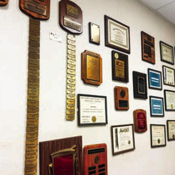 The walls in Rohde’s office are lined with awards he’s won throughout his 50 years in the insurance business.