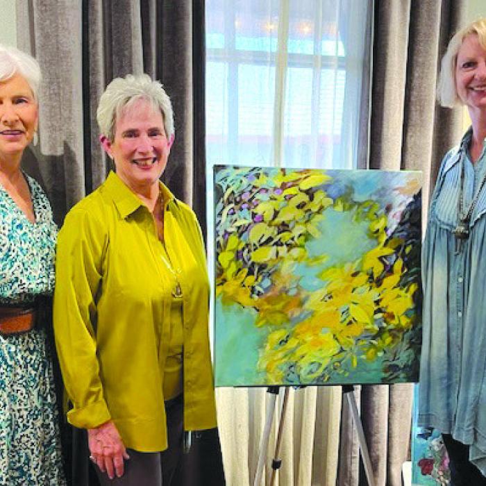 Pictured from left: hostess Kathy Valtassaros, artist Mary Quiros (standing next to her work), and Sandra Borne.