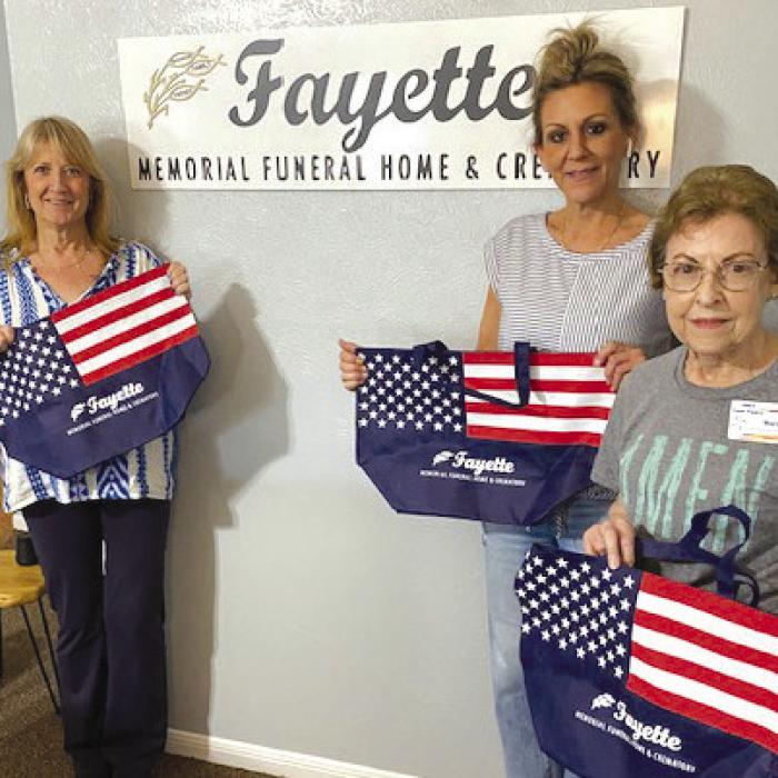 Fayette Memorial Funeral donated 100 reusable bags to Mary Vasek, AMEN Board Member. Making the presentation were Tanya Clark-Landreth, Operations Director and Jennifer Bernshausen, Funeral Director in Charge.