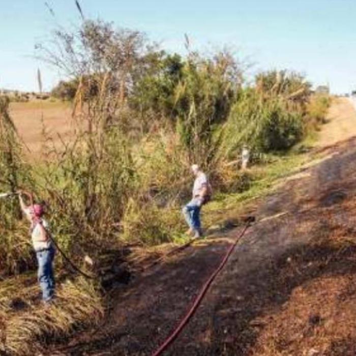 Schulenburg volunteer firefighters put out a grass fire on the side of US 77 near Swiss Alp Tuesday. Fire Chief Jeff Proske said the fire may have been caused by a blown out tire from a passing vehicle. Photo by Andy Behlen