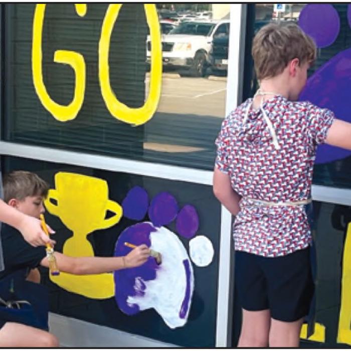 La Grange Elementary students are helping to get the campus painted purple and gold for the upcoming Leopard homecoming (Oct. 9). The art students painted their own design on the elementary windows recently. Returning this year is a local window decorating contest. Photo courtesy of Regina Walker