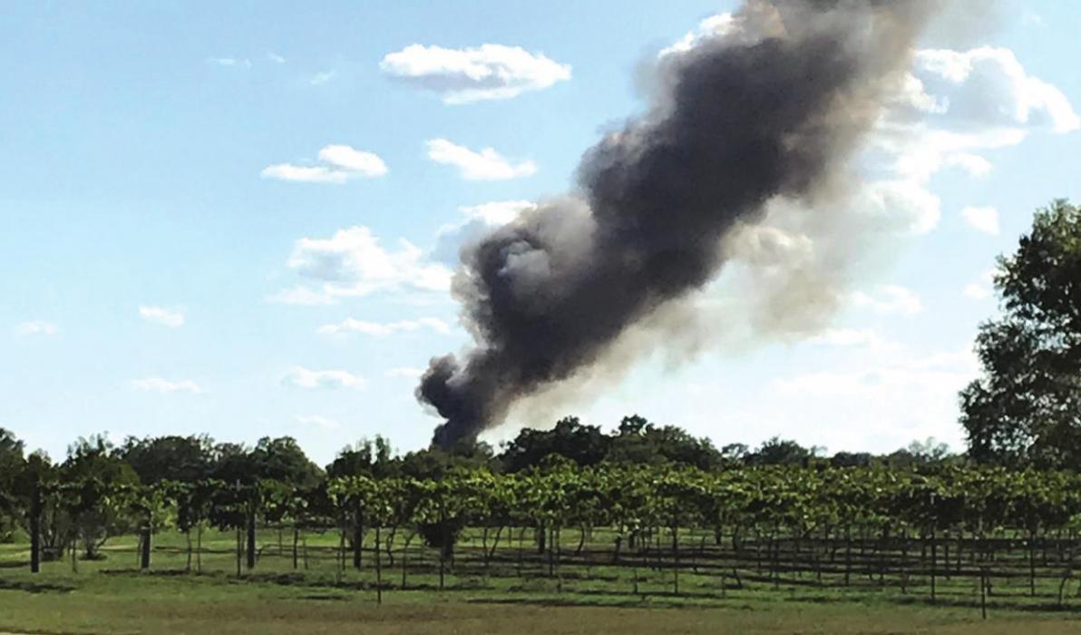 Left, Ken Yoder of West Point snapped this photo from his property showing the huge plume of black smoke as the house burned Saturday.
