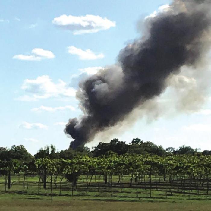 Left, Ken Yoder of West Point snapped this photo from his property showing the huge plume of black smoke as the house burned Saturday.