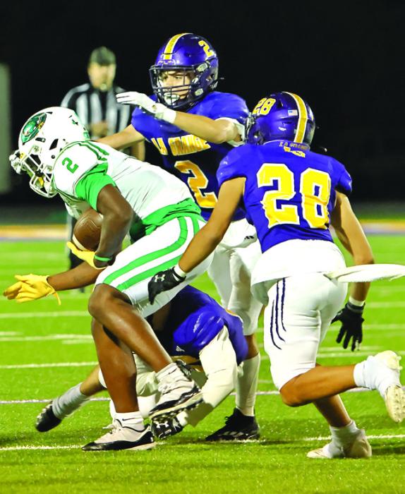 La Grange’s Max Dixon (2) and Tye Johnson (28) converge on Cuero’s Kenneth Jackson to try to make a tackle Friday. Photo by Darrell D. Gest