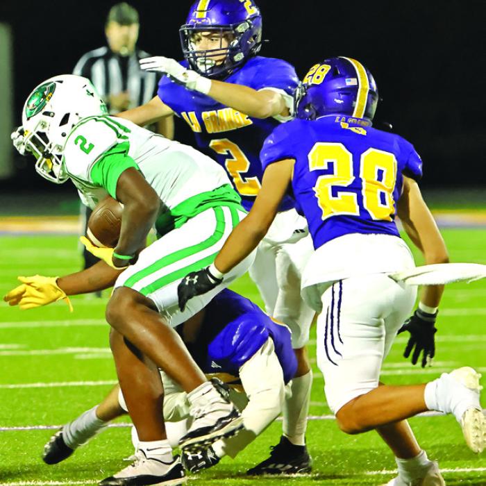 La Grange’s Max Dixon (2) and Tye Johnson (28) converge on Cuero’s Kenneth Jackson to try to make a tackle Friday. Photo by Darrell D. Gest