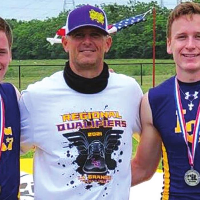 Left to right: LG’s Blake Truss, regional third place in the pole vault, coach Kevin Pittman, and Dylan Truss, regional runner-up.