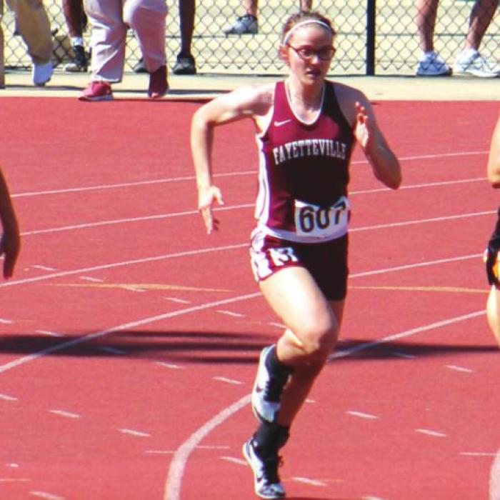 Fayetteville’s Brooklyn Jaeger surges ahead at the start of the 100 meters Saturday. Photo by Ann Pape
