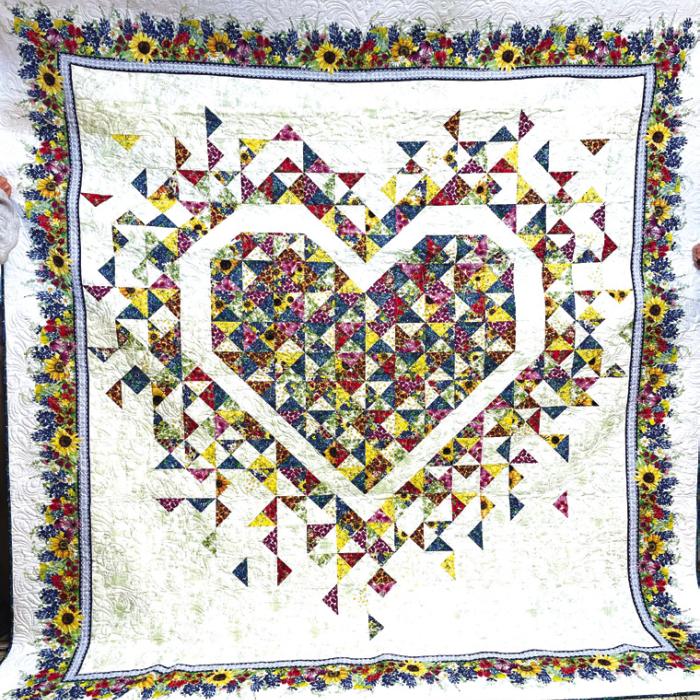 Two entries in the Houston Livestock and Rodeo were from the Colorado Valley Quilt Guild in La Grange. Anita Todd placed Best in Show for her quilt titled “Hankie Panky (above, left). Also, Barbara Schellberg placed third in the piecing category. Barbara made the quilt, shown above, right, with Kathi Babcock machine quilting. It is titled “Exploding Wildflowers.”