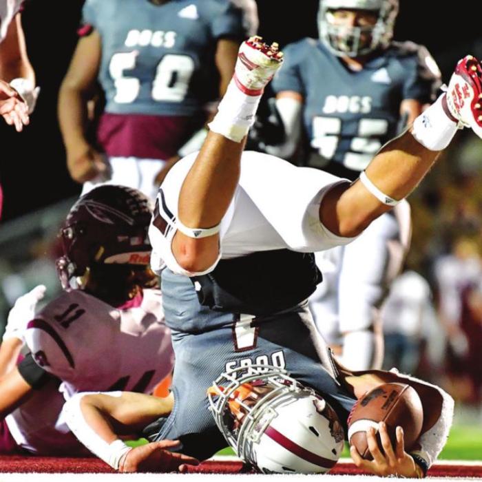 Fidel Venegas gets through the Ganado defense the best way he can to pick up a six points for the Flatonia Bulldogs Friday night in Flatonia. Photo by Stephanie Steinhauser