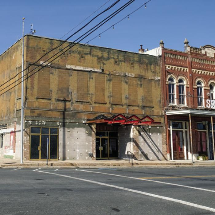 Pictured above, left Schulenburg City Hall as it appeared this week after workers removed the metal and marble facade. Above, right, an old photograph of the building as it appeared in the early 1900s.