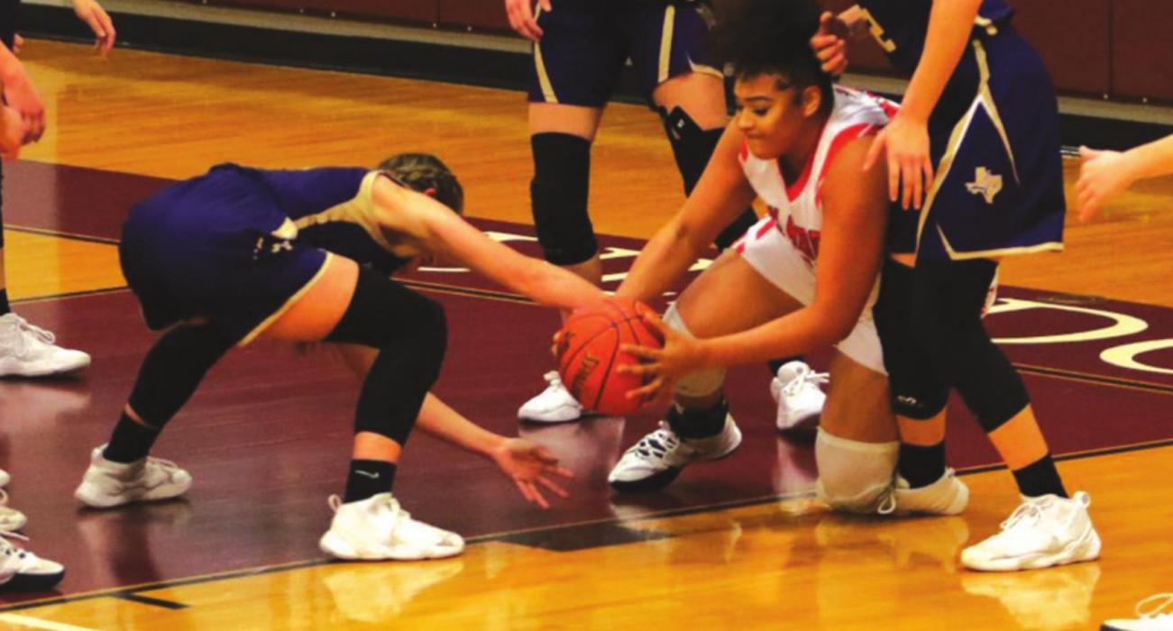 Schulenburg’s Airyanna Rodriguez fights for a loose ball with a Shiner player during Friday’s district tiebreaker game in Flatonia. Shiner won 60-56 to grab the runner-up playoff spot and so the Schulenburg Lady Horns head to the playoffs as the No. 3 seed out of District 28-2A. Photo by Audrey Kristynik