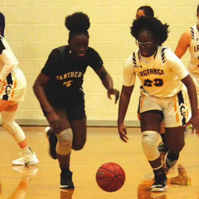 La Grange’s MaKenna Mitchell races this Eastside player to a loose ball Tuesday.