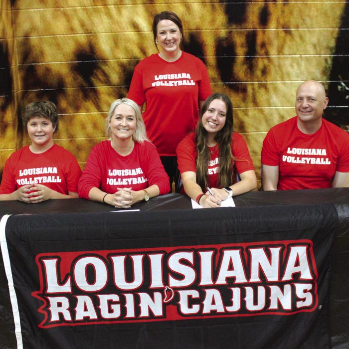 La Grange volleyball star Maddi Fritz officially signed a scholarship agreement to play for The University of Louisiana-Lafayette Wednesday. Standing behind is her high school coach Leslie Coltrain. Seated, left to right, are her brother Cole, mother Amy, Maddi, and her father Eric. Photo by Jeff Wick