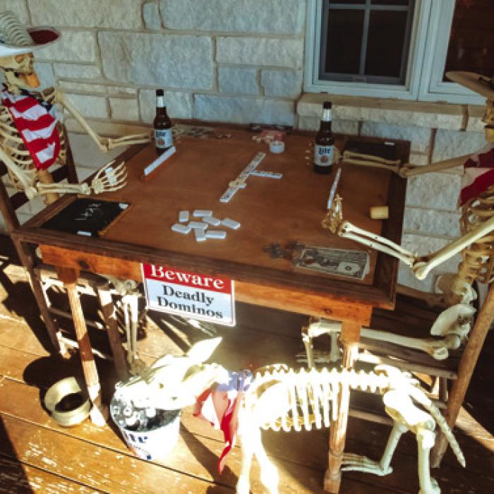 A pair of skeletons play a game of “Deadly Dominos” on the Tofels’ front porch. Photo by Andy Behlen