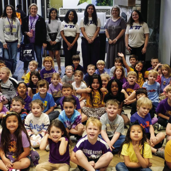 Kindergarteners pose for a group photo with their teachers and staff from NBT.