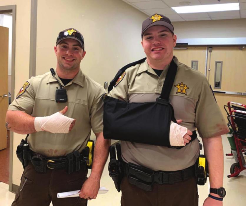 Fayette County deputies Adam Mack, left, and Ryan Meager were able to smile even after being injured in a lengthy altercation Friday morning. Fayette County Sheriff ’s Offi ce photo