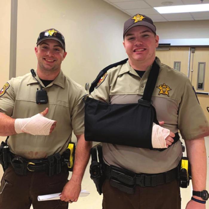 Fayette County deputies Adam Mack, left, and Ryan Meager were able to smile even after being injured in a lengthy altercation Friday morning. Fayette County Sheriff ’s Offi ce photo