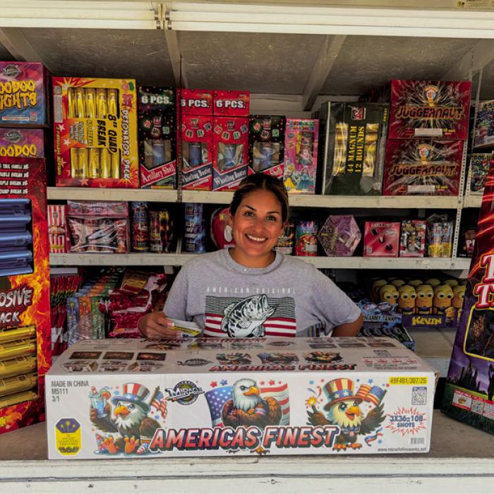 The Mr. B Fireworks stand on the Bluff south of La Grange opened Tuesday, June 30. Stand operator Blanca Villanueva is pictured above with some of the most spectacular fireworks bundles available for purchase. The America’s Finest package, in the center, features 108 shots for a price of $239. She called it “the most bang for your buck.” Photo by Andy Behlen